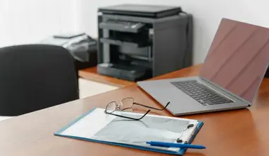 Laptop and printer set up on an office desk