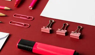Colourful pens, paperclips and binder clips on a desk