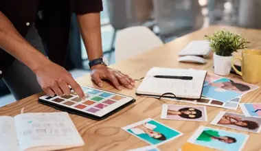 Colour swatches and printed photo samples on a desk