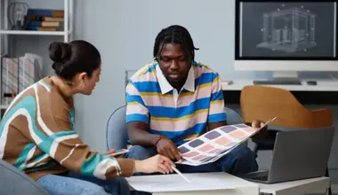 Designers reviewing colour swatches and a brand mockup